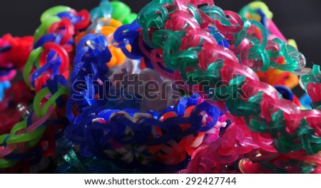 colorful background rainbow colors rubber bands loom bracelets on black background