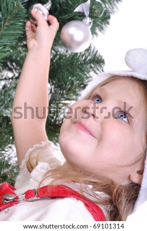 Happy smiling kid in Christmas costume preparing the Christmas three