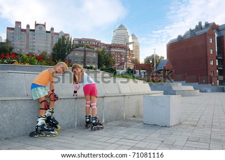 kids on roller blades in the park against of a modern urban scene