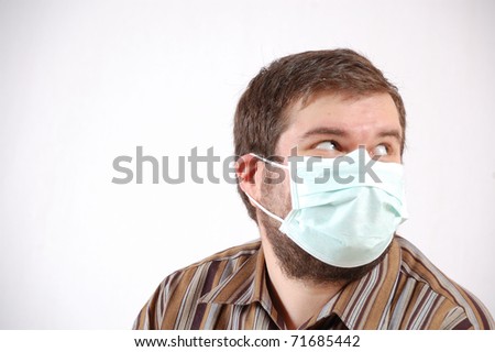 large-built mid-adult man wearing a surgical face mask