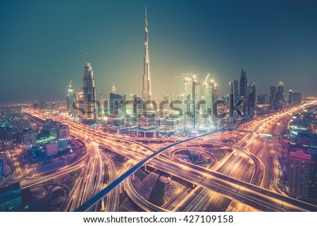 Dubai skyline at night with beautiful city with lights close to it\'s busiest highway