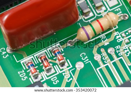 Macro shot of printed circuit board (PCB) with resistors, diodes and capacitors.