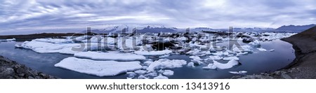 beautiful panorama scenery with a floating icebergs in the foreground and a glacier in the background; Jökulsárlón; Iceland