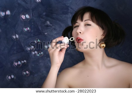 Girl allows soap-bubbles