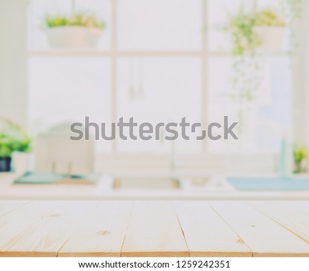 Wood table top on blurred kitchen background