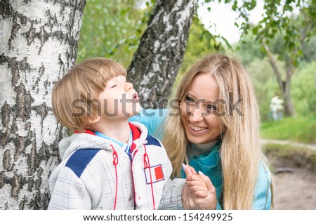 Happy family in the forest, focus on mother