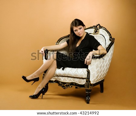 young beautiful woman sitting in antique armchair