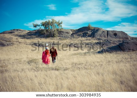 man and woman in kazakh national costume in the steppe