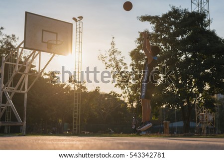Basketball players playing basketball outdoor, basketball player shooting in a playground