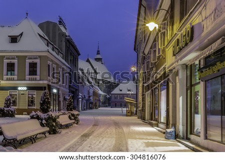 Brasov, Transylvania, Romania - December 28, 2014: A view of one of the main streets in downtown Brasov leading to the Council Square where the medieval Black Church is found