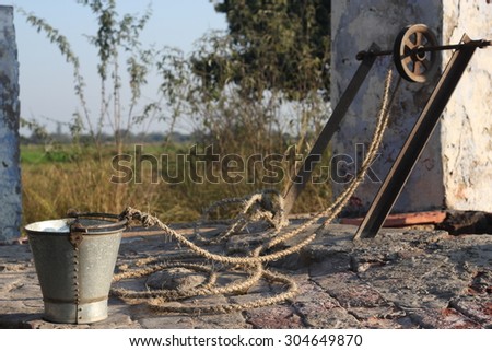 old water well with a bucket in remote area of India