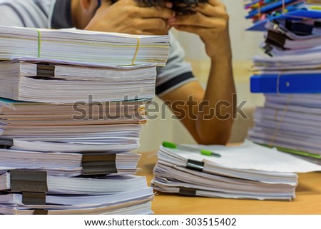 Pile of documents on desk for managed.
