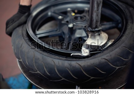 Motorcycle tire repair by mechanic