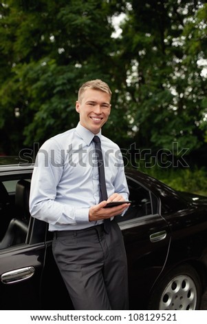 Businessman with e-reader. Smiling.