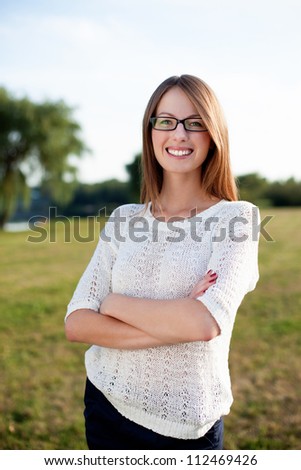 Beautiful woman smiling outdoors wearing glasses