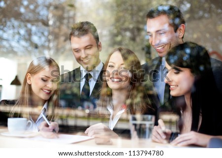 Group of business people in coffee shop.