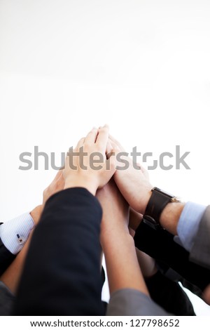 Group of business people joining hands together isolated.