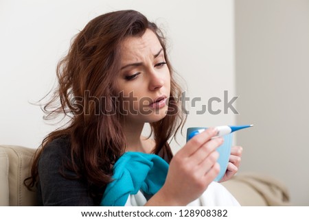 Sick woman measuring body temperature