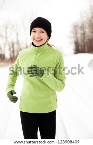 Happy woman running in winter