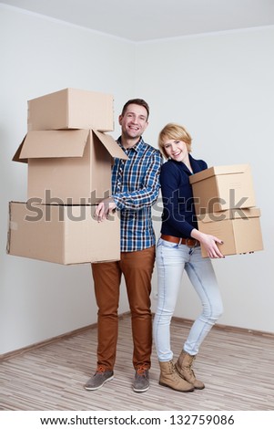 Couple in new home holding boxes Couple in new home holding boxes