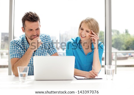 Couple discussing new project on the laptop Teamwork concepts Couple discussing new project on the laptop Teamwork concepts