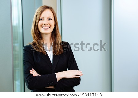 Confident business woman stands in the office