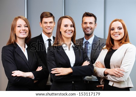 Confident business people standing with female leader