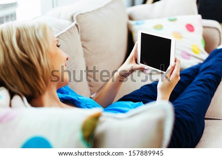 Happy Woman With Tablet On Couch