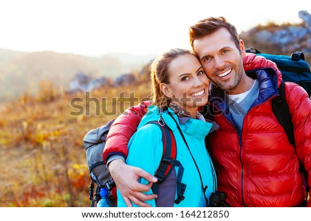 Young Couple In Mountains Smiling