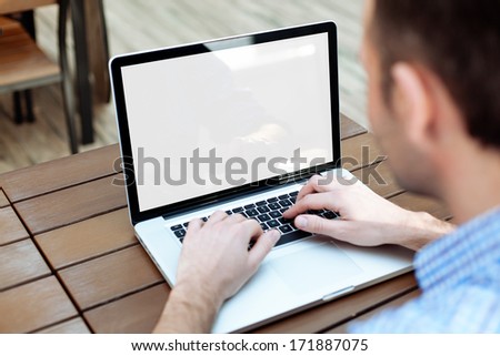Man Typing On A Laptop