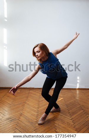 Female ballet dancer stretching her arms in a balanced move