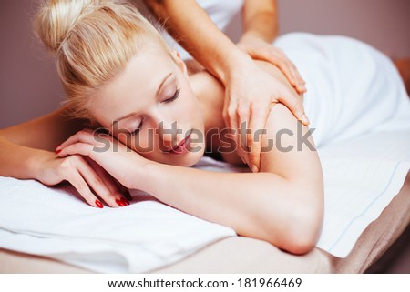 Pretty blond woman having a massage back treatment