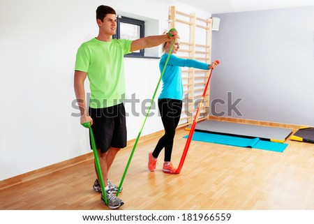 Two young people exercising with resistance bands