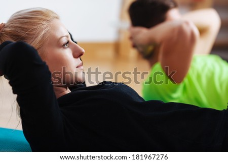 Close-up of a young woman doing sit-ups