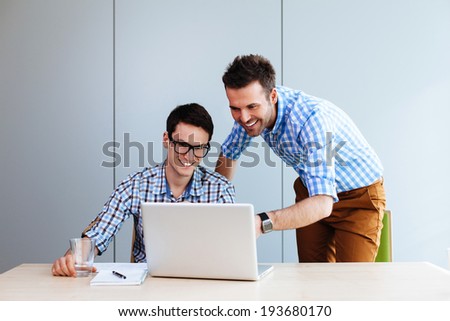 Two web designers looking at a website they designed