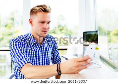 Portrait of a young man connecting with somebody via a video call