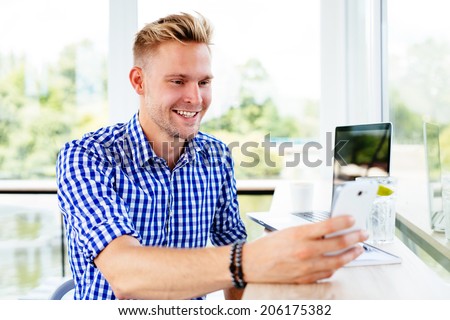 Photo of a young man video calling a friend