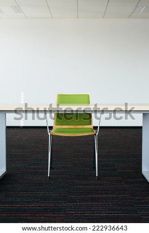 Photo of an empty office room with a desk and chair