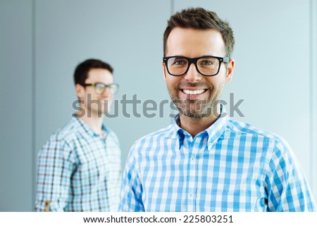 Two computer geeks standing in office Two computer geeks standing in office