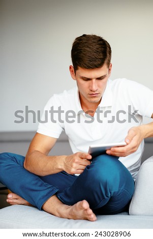 Young man reading digital tablet