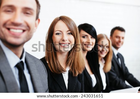 Young businesswoman sitting with business partners. Human resources concept