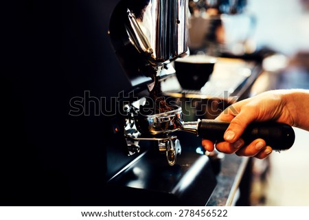 Closeup of barista grinding coffee