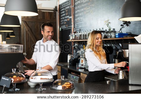 Two baristas preparing coffee at coffee-shop