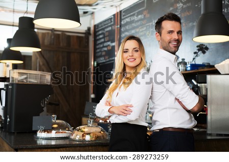Small business partners standing together at their coffee shop, cafe
