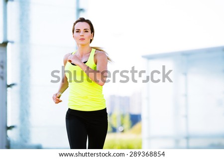 Photo of determined young woman running