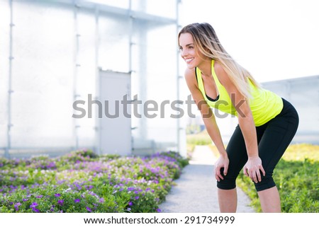 Young female athlete resting during run workout