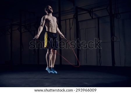 Portrait of young male athlete skipping rope