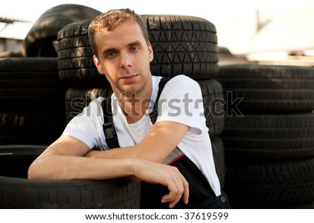 Young mechanic have break outside car service