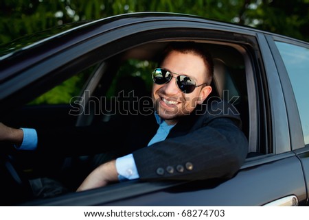 businessman in car smiling