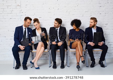 Group of happy young people waiting for job interview